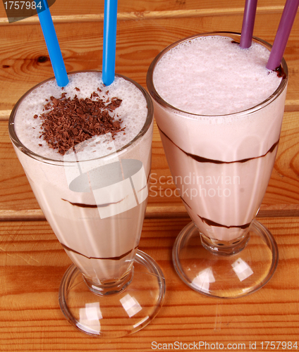 Image of two cocktails with straw on wooden background