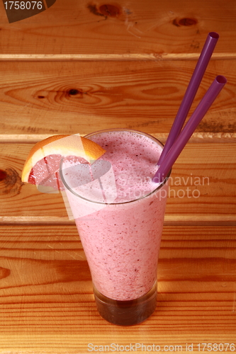 Image of milkshake on wooden background