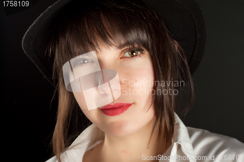 Image of young beautiful girl on black hat