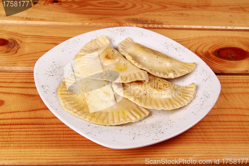 Image of Cooked raviolli on a shiny white plate