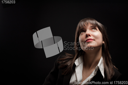 Image of Portrait of brunette girl on dark background