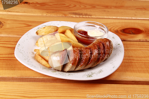 Image of grilled sausages with French fries and ketchup