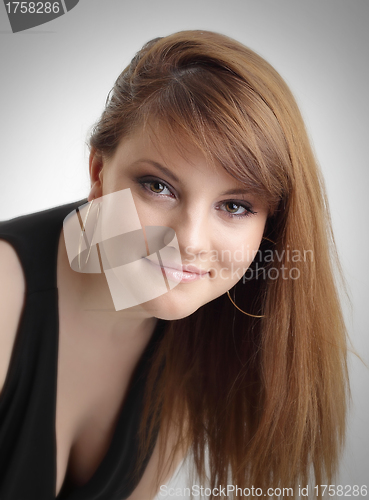 Image of Portrait of beautiful young woman with long straight brown hair