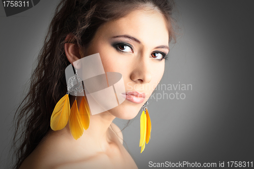 Image of cute girl with beautiful yellow earrings