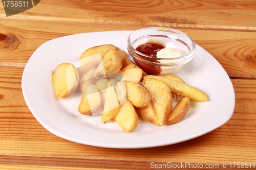 Image of coocked potatot with ketchup isolated