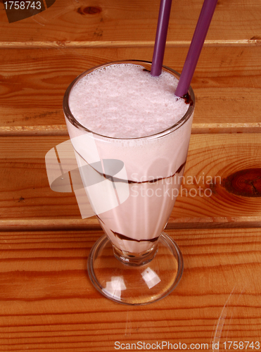 Image of milkshake on wooden background