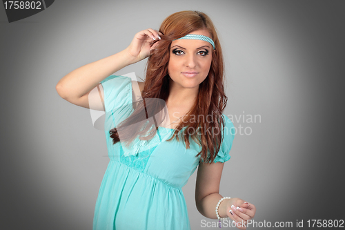 Image of Beautiful young woman in blue dress. Isolated