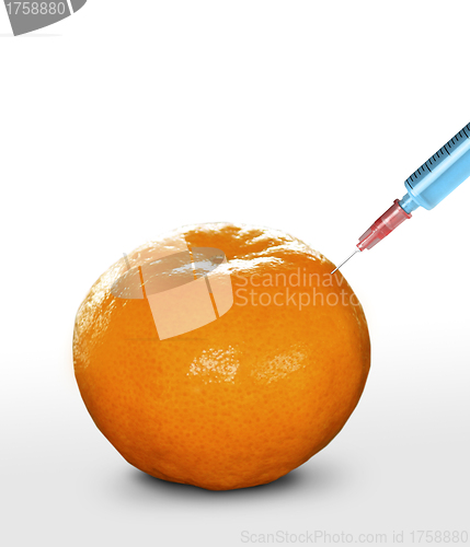 Image of syringe sticked into orange,GMO