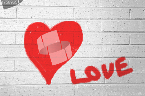 Image of Red heart on the white wall and text "love"