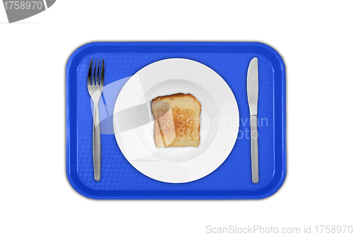 Image of Set of utensils arranged on the table with plate and toast