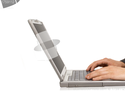 Image of Businessman typing on a notebook