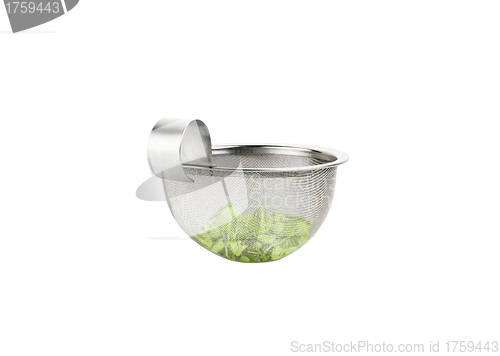 Image of Tea strainer loaded with green tea