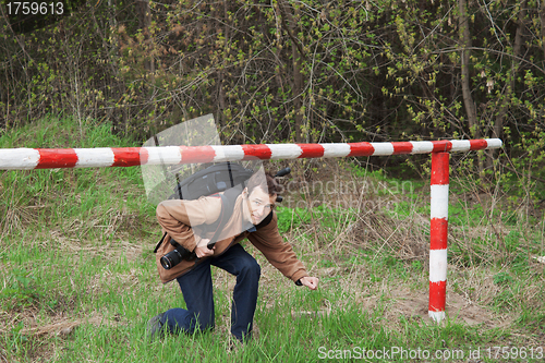 Image of A young man passes under the barrier