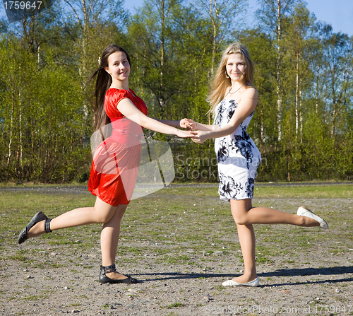 Image of Two girls dancing in the park