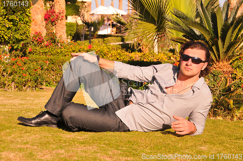 Image of Man posing in sunglasses