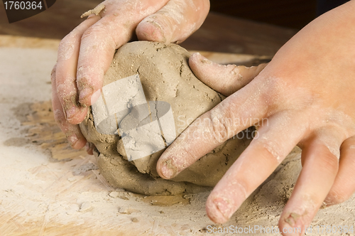 Image of Child hands of a potter