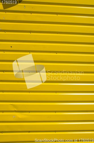 Image of Wall made of yellow wooden planks. 