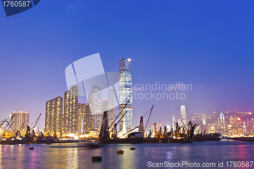 Image of Hong Kong harbor at sunset with industrial ships