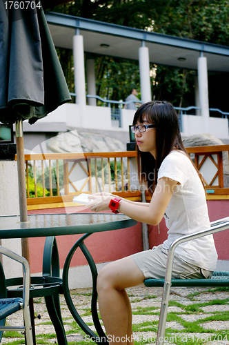 Image of Asian student reading book in school