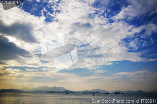 Image of Blue sky with moving clouds over the ocean