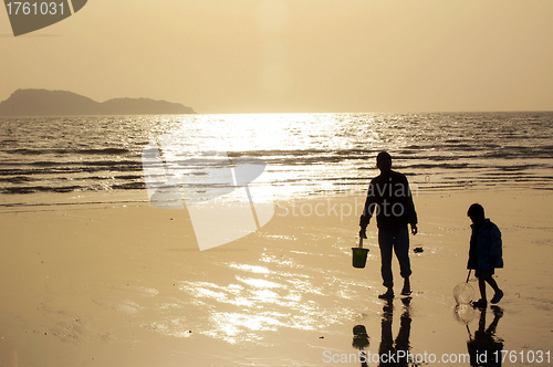 Image of Father and son under sunset