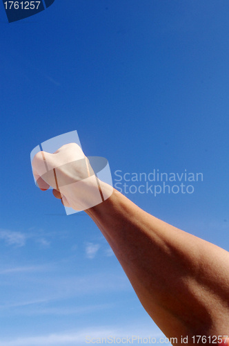 Image of Fist under blue sky