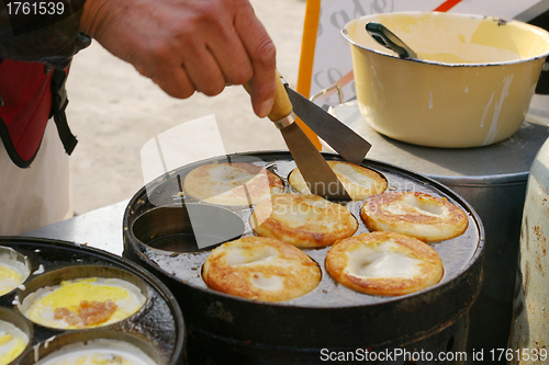 Image of Chinese street food, egg and meat cake.