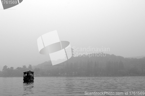 Image of Traditional wooden row boat on famous West Lake, Hangzhou, China