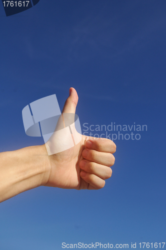Image of Thumbs up in blue sky