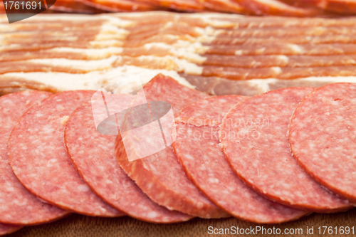 Image of Assorted Slice Sausage and Bacon on Cutting Board