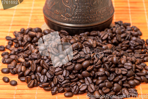 Image of Cezve and Coffee Beans on Bamboo Mat