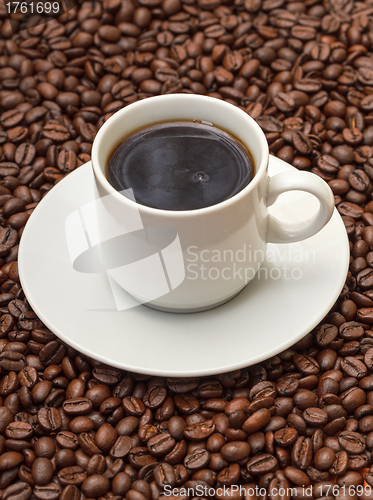 Image of Cup with Hot Coffee on Coffee Beans