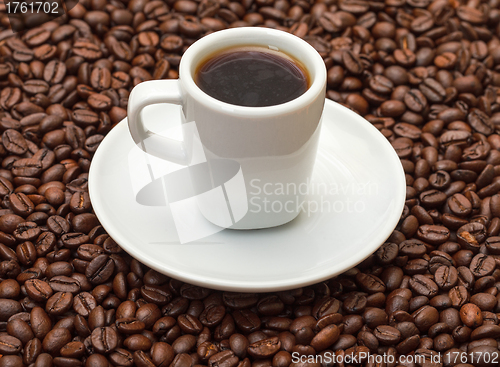 Image of Cup with Hot Coffee on Coffee Beans