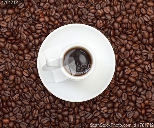 Image of Cup with Hot Coffee on Coffee Beans