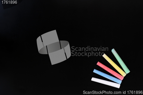 Image of Colorful chalk on a blank blackboard