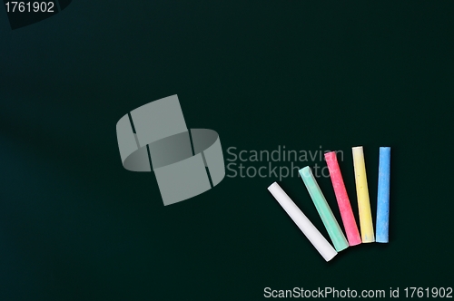 Image of Colorful chalk on a green chalkboard