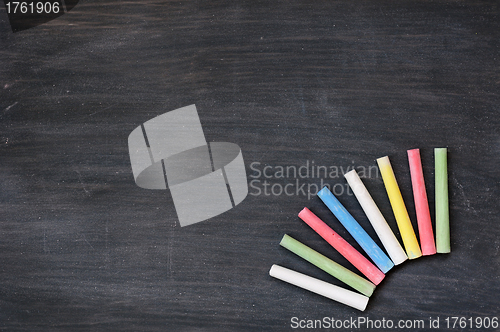 Image of Colorful chalk on a blank smudged blackboard