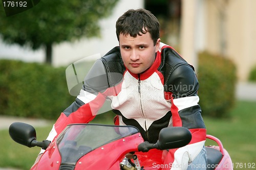 Image of Man on a red bike