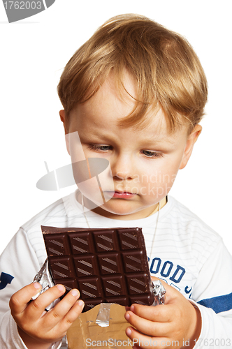 Image of The little boy eats chocolate