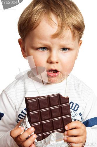 Image of The little boy eats chocolate