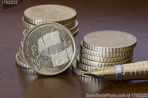 Image of Stack of 50 cents euro coins  and pen