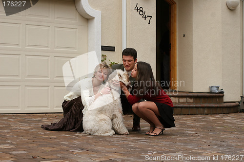 Image of Happy family with a dog