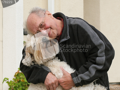 Image of Happy senior man and his dog