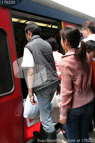 Image of People boarding a train