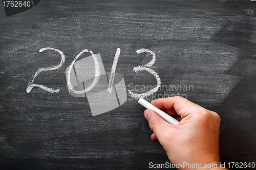 Image of 2013 written with chalk on a smudged blackboard