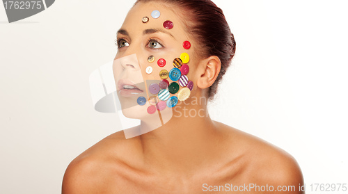 Image of Woman with buttons on her face