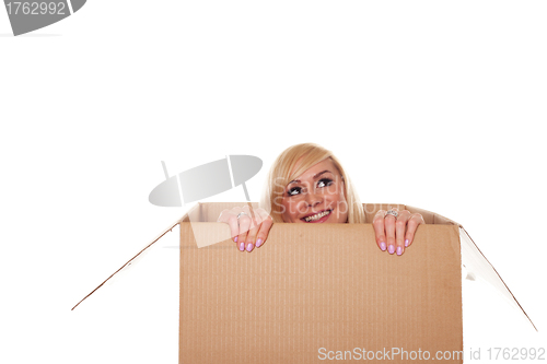 Image of Smiling young blonde emerging from a box