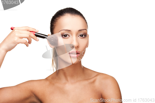 Image of Young beautiful woman applying makeup