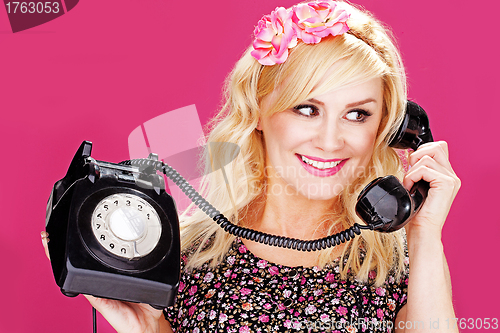 Image of Woman talking on old telephone