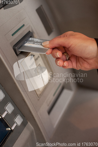 Image of Female hand inserting ATM card